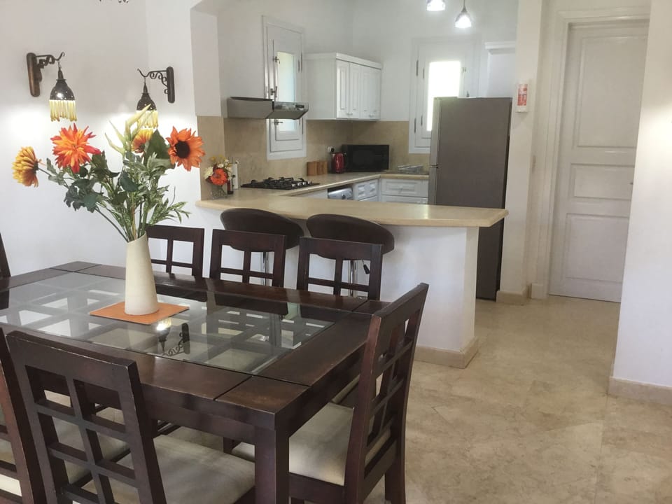 Dining room adjacent to patio doors to pool area