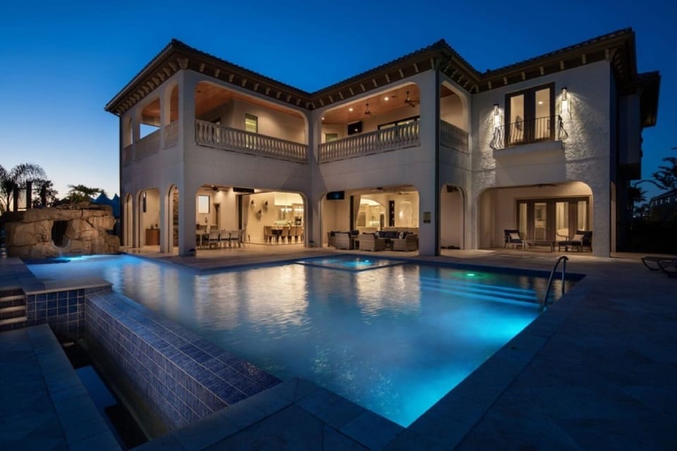 Twilight view of infinity pool and outdoor lanai.