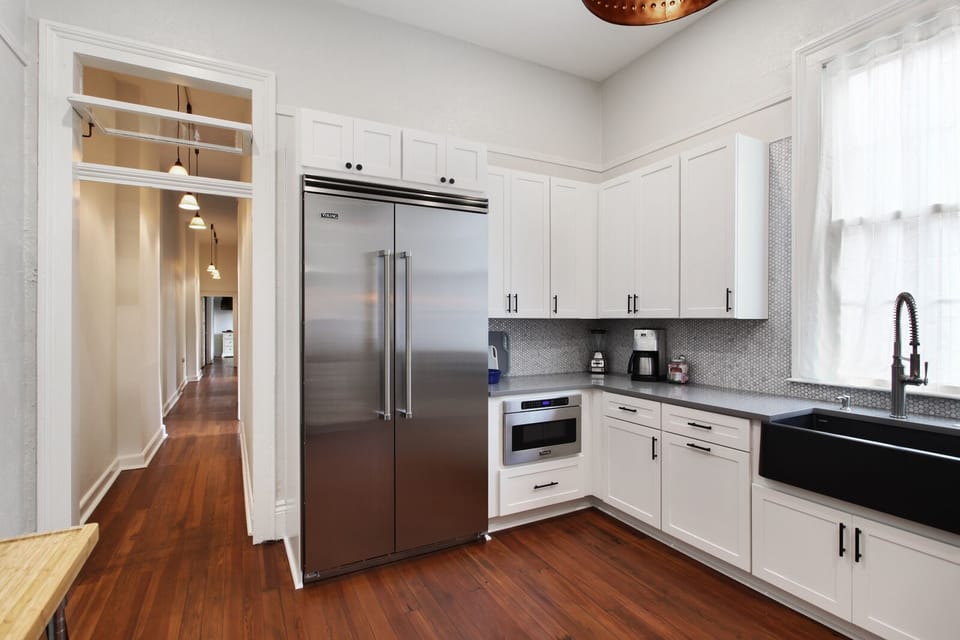 Quartz countertops and marble penny round backsplash 