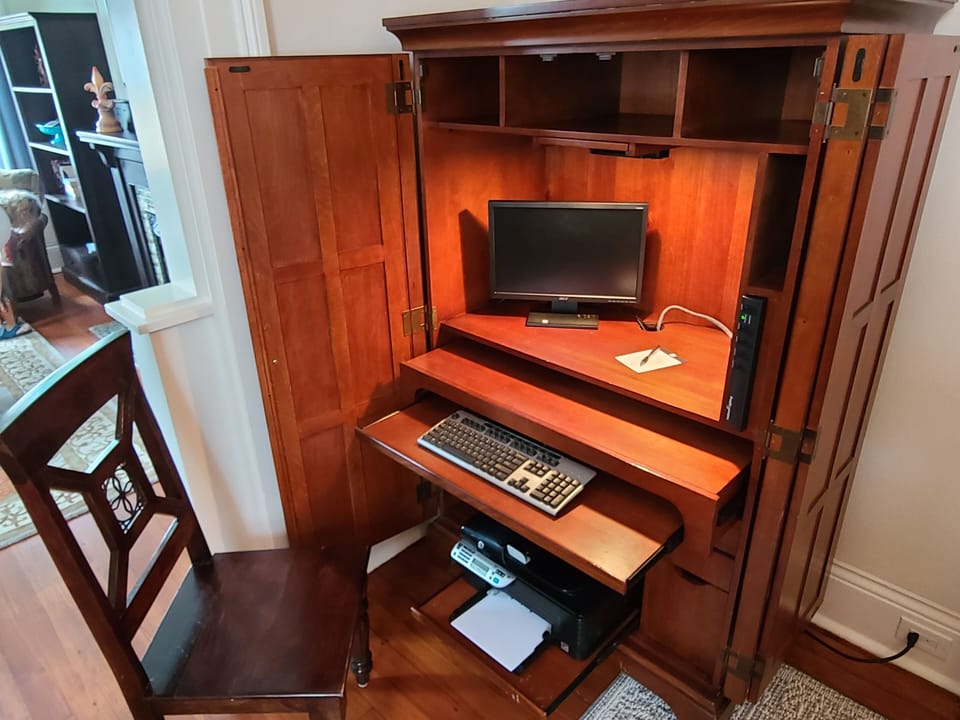 Armoire opens up into work station for your laptop.
