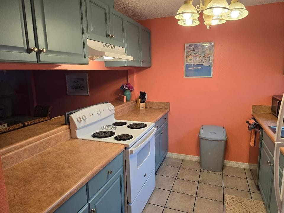 Remodeled kitchen with painted cabinets and stainless appliances 