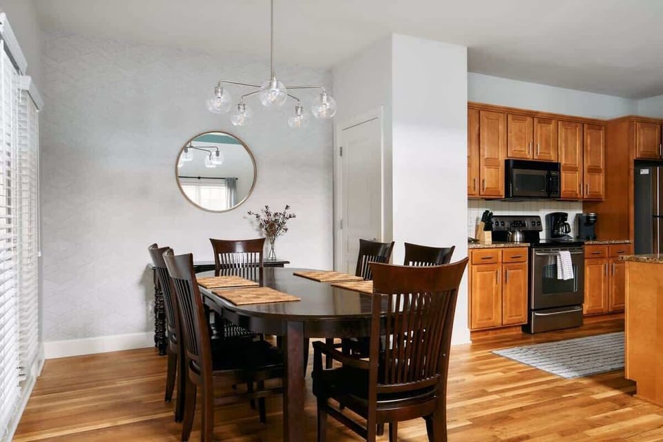Dining area with an abundance of chairs for gathering around the table!