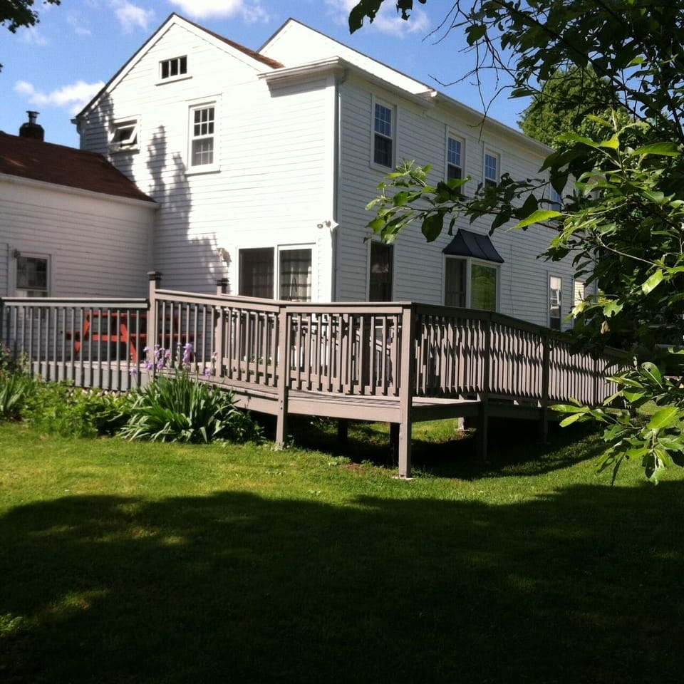 The dining area has a sliding glass door that leads to the deck.