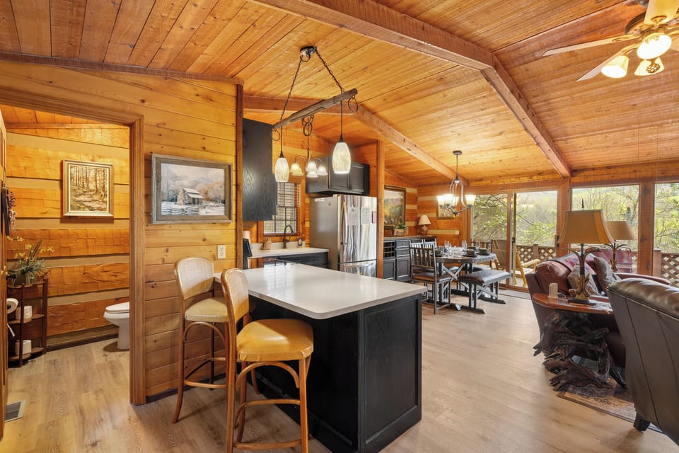 Gather, cook, and unwind in this open-concept cabin kitchen and living space.