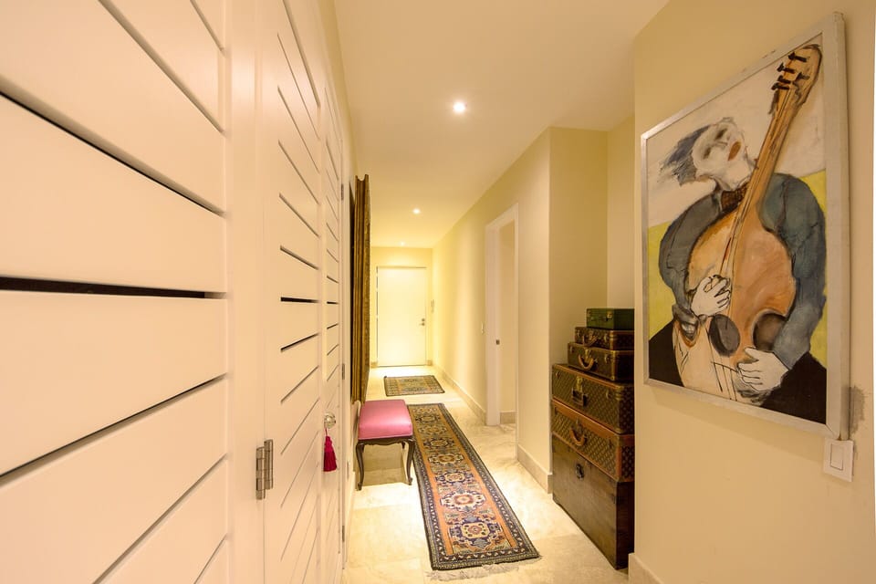 Grand hallway entrance filled with beautiful artwork and Vintage Vitton.