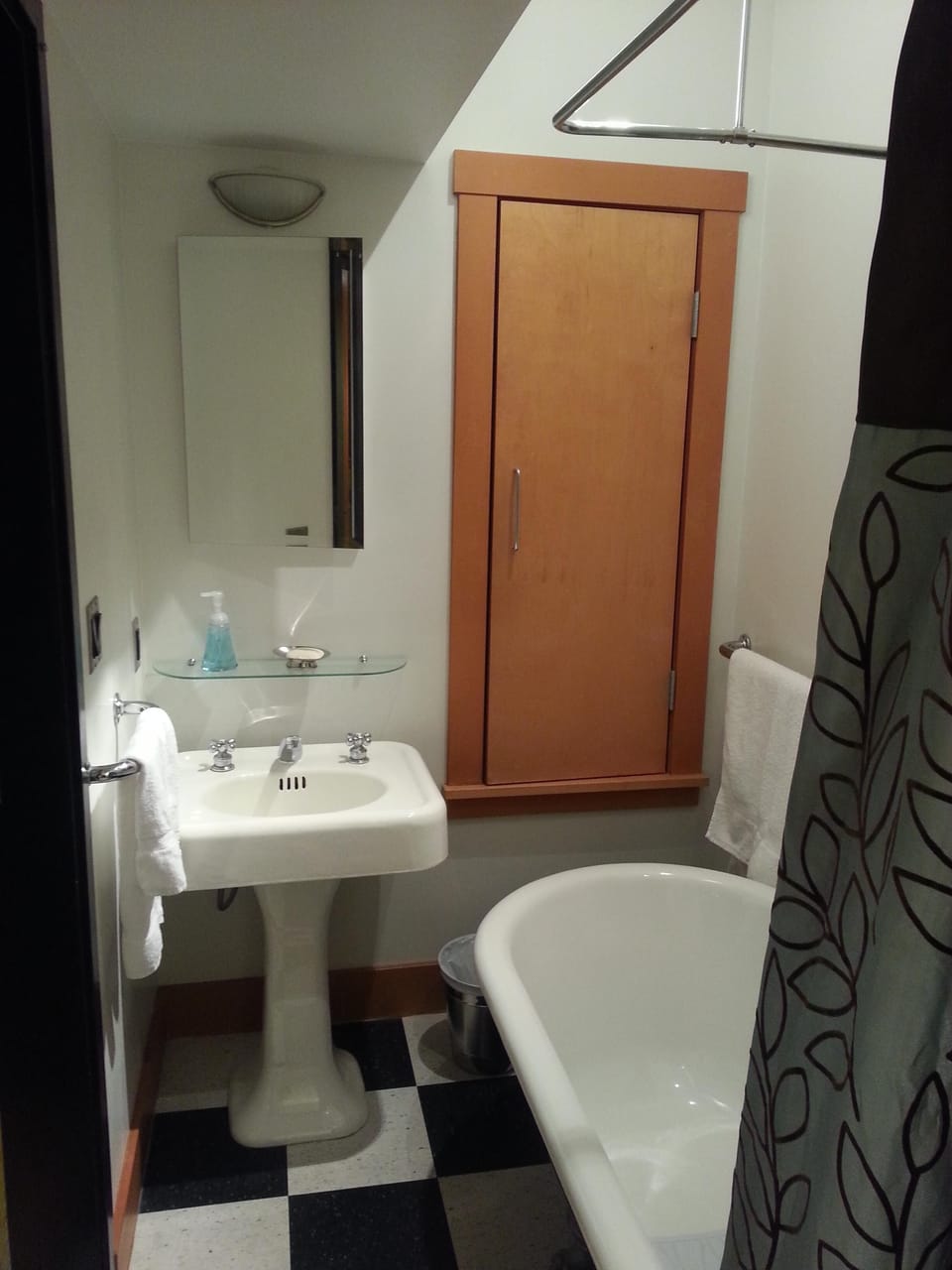 bathroom with reclaimed old cast iron tub and sink. (very Seattle)
