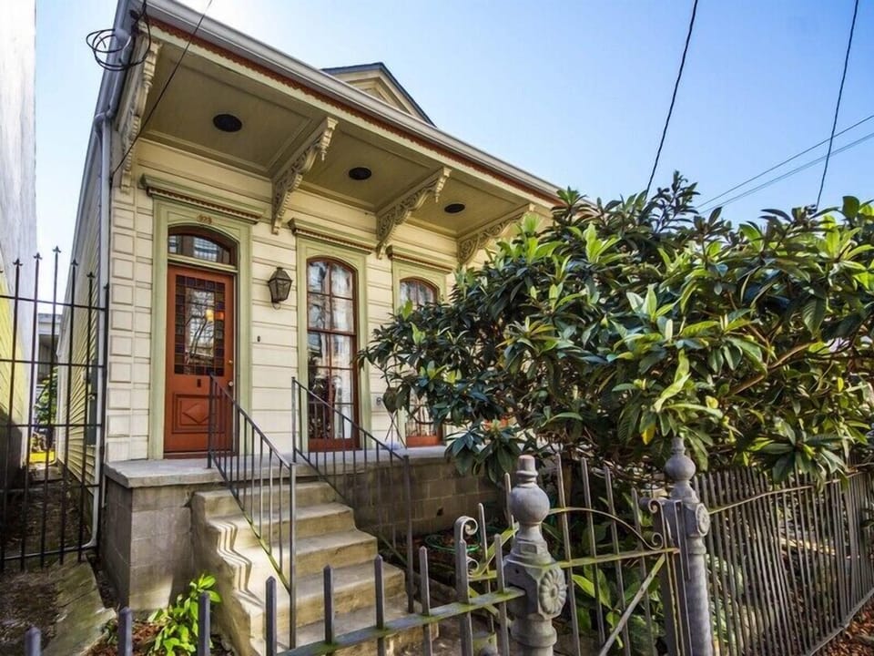 Welcome to our home! This is the formal street entrance with beautiful loquat tree and New Orleans iron work.
