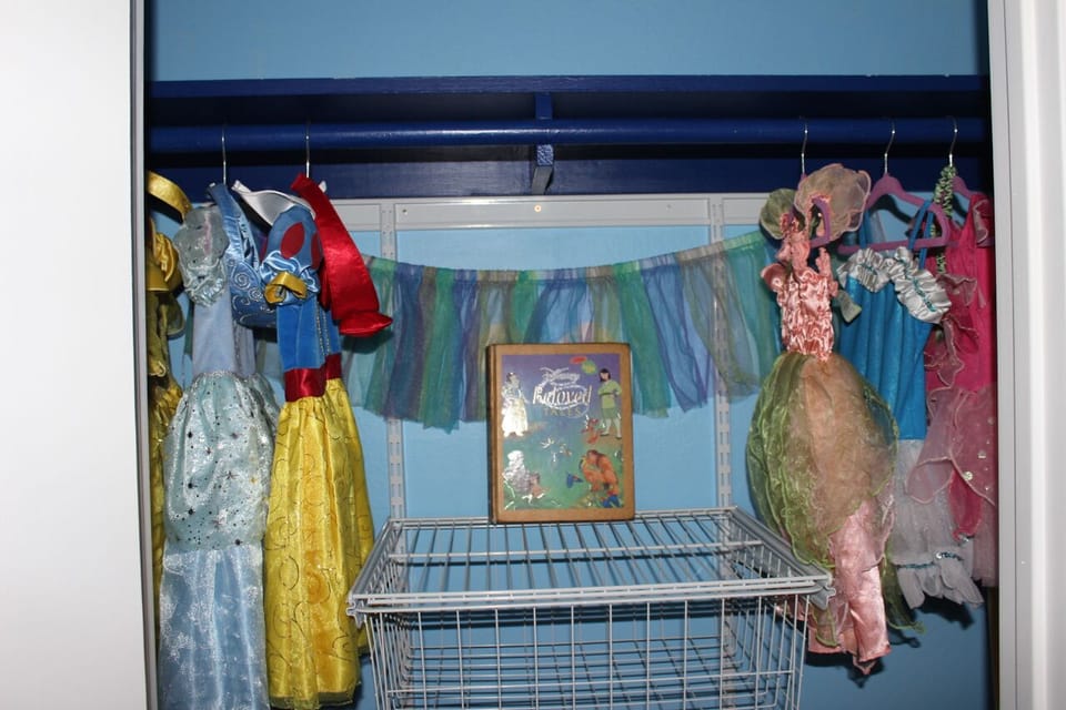 Princess costumes in kids bedroom.  