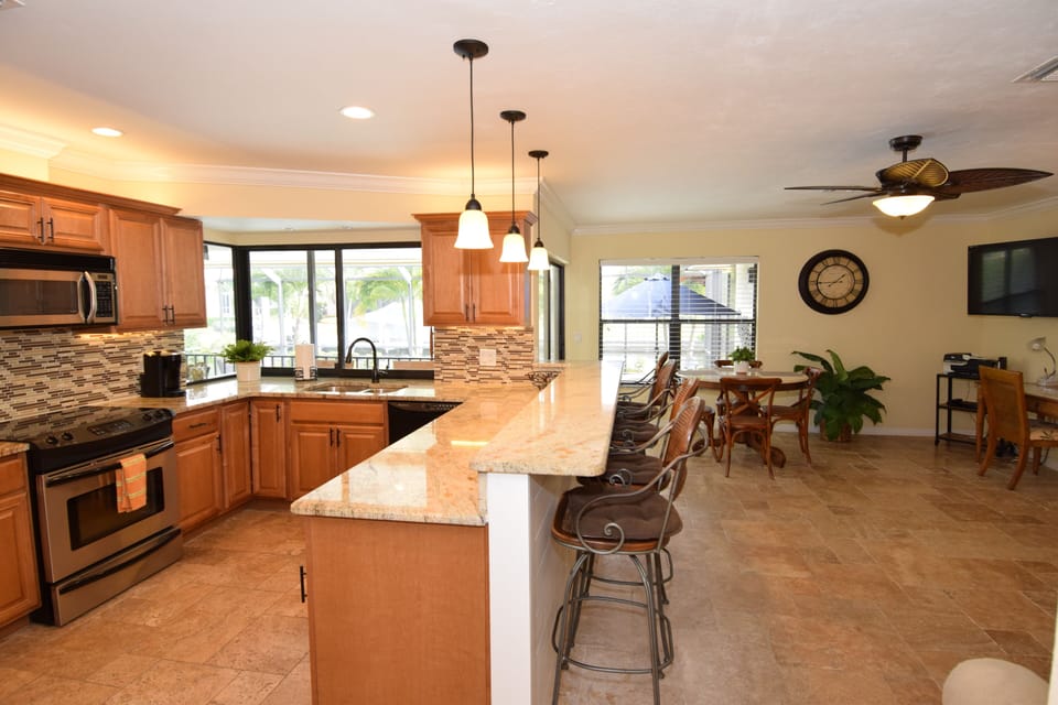 View of the kitchen and second living space from the entryway. 