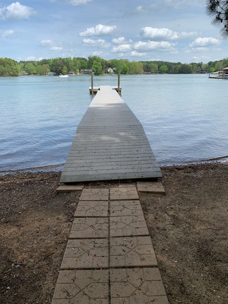 Trex dock and paver walkway to the house with afternoon shade.