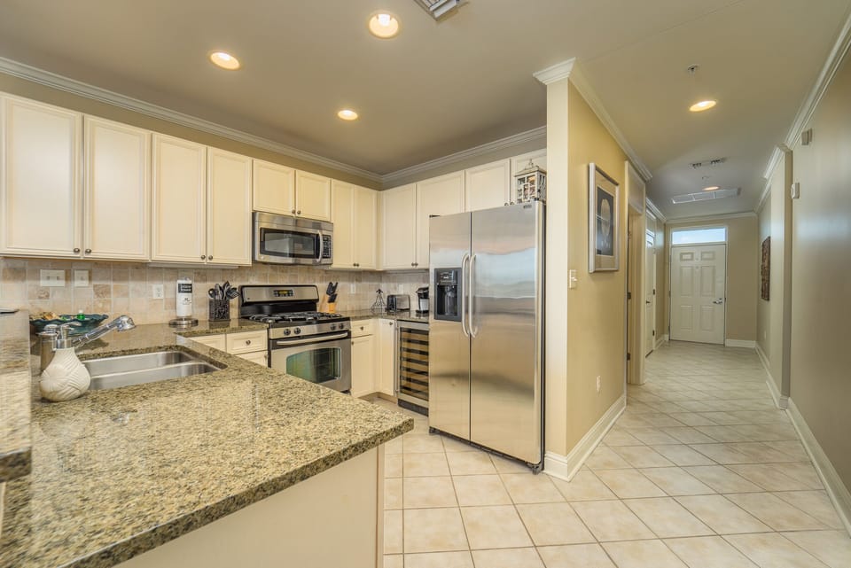 Kitchen with granite counter tops and stainless steel appliances.