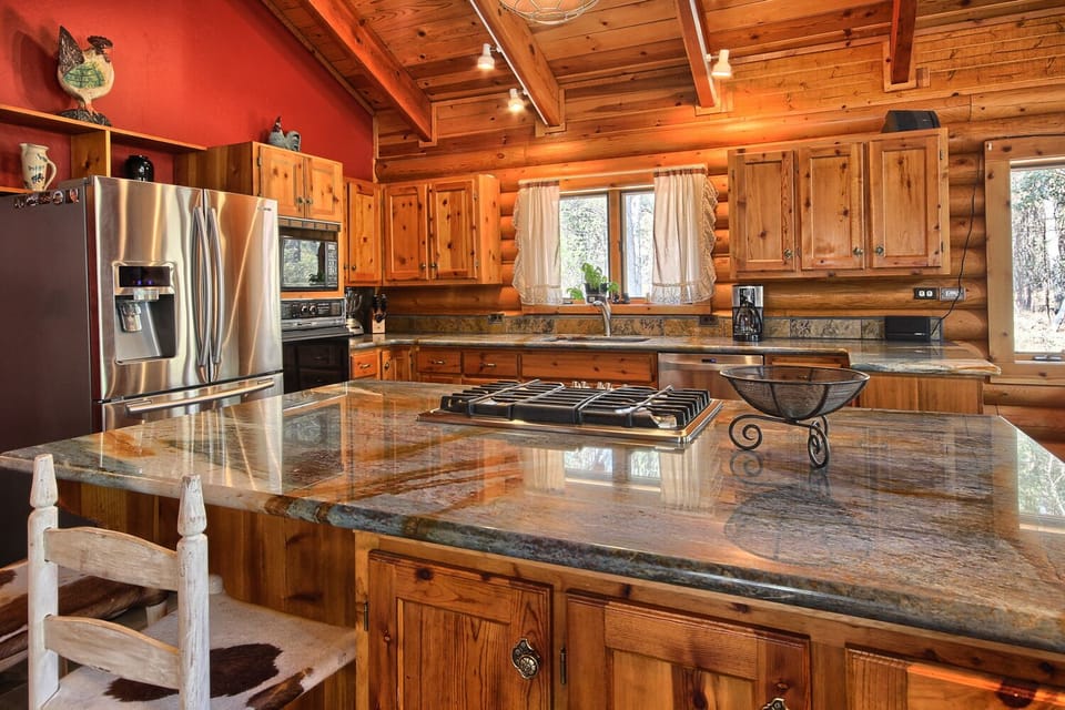 Gourmet kitchen fully equipped with cookware and serving ware.