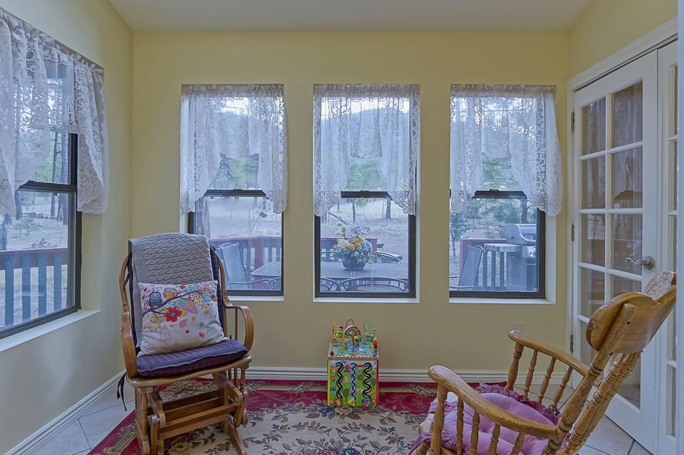 Sun room for reading a book with a few toys for kids.