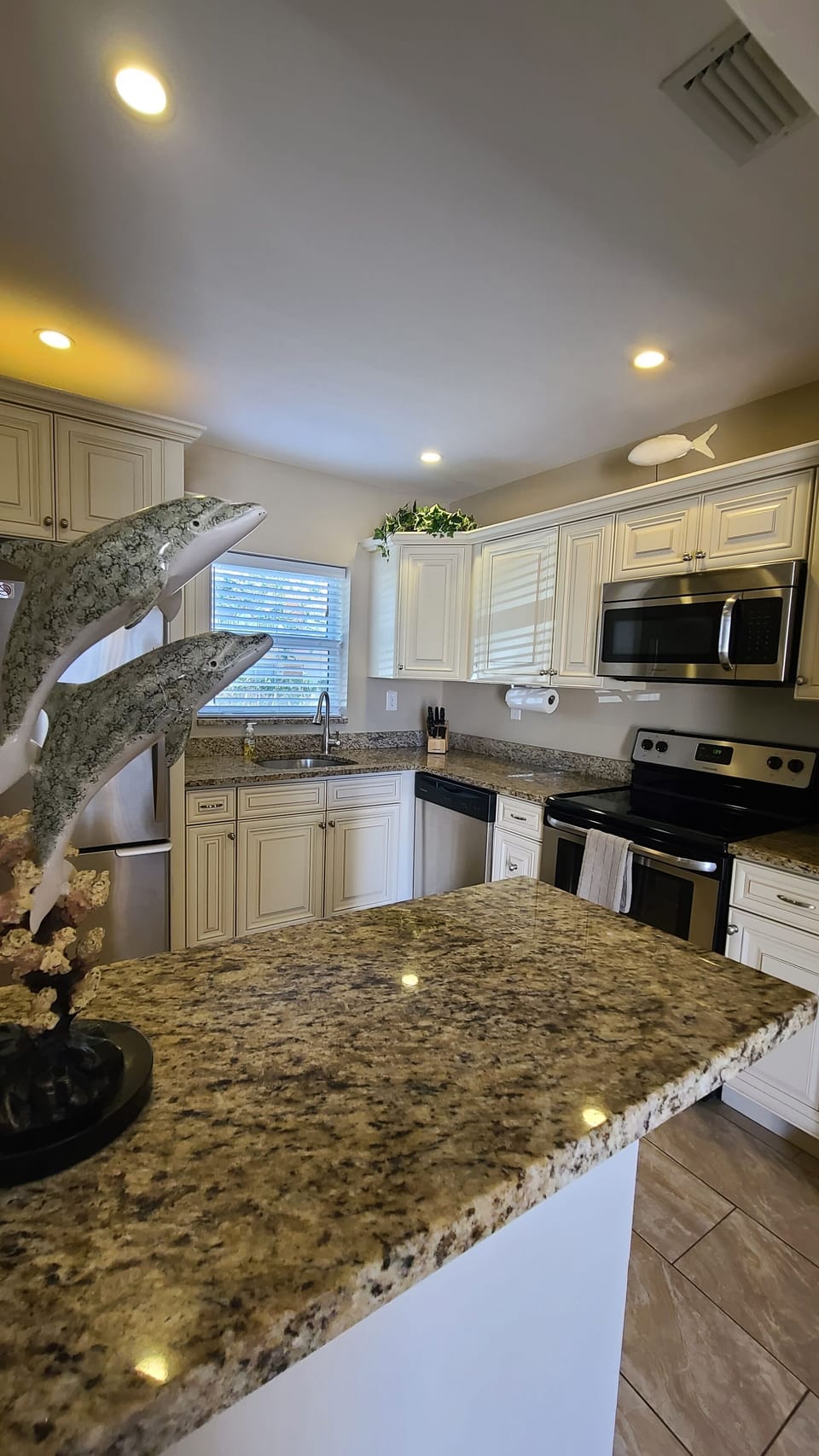Large kitchen with kitchen utensils, coffee pot and filters. 