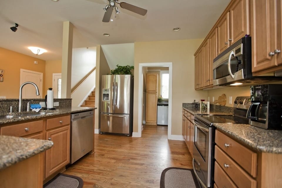 Kitchen has a flat top stove with oven, a convection microwave, and a dishwasher