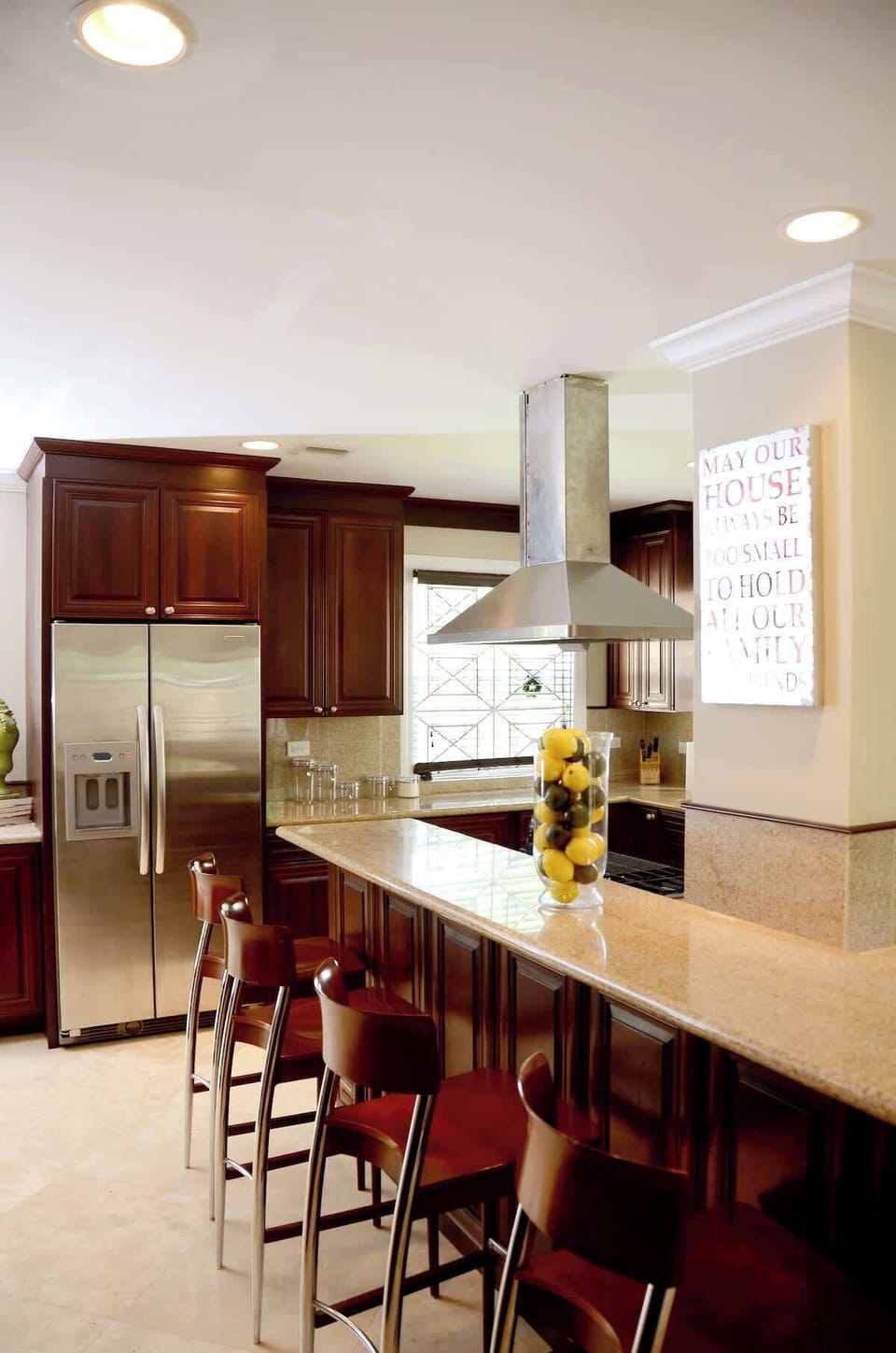 Modern kitchen fully equipped with stainless steel appliances and a wine cooler.