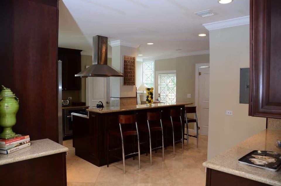 The kitchen allows lots of natural light in and has a breakfast counter 