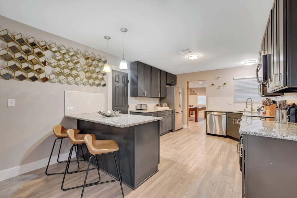 Fully equipped kitchen with island seating and modern appliances

