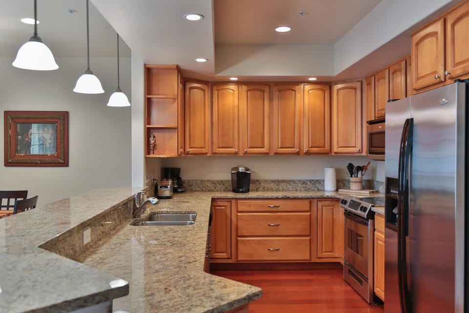 Gourmet kitchen: granite counters, rose wood floors, bright light & space.