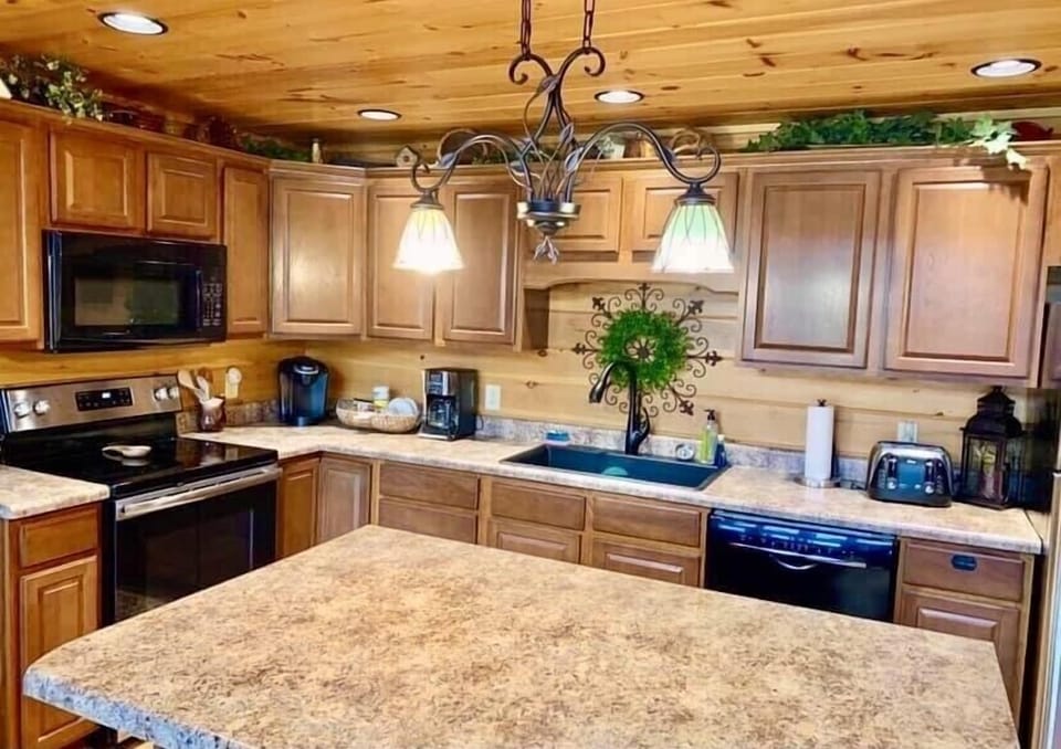 Kitchen fully stocked with coffee makers and cooking utensils
