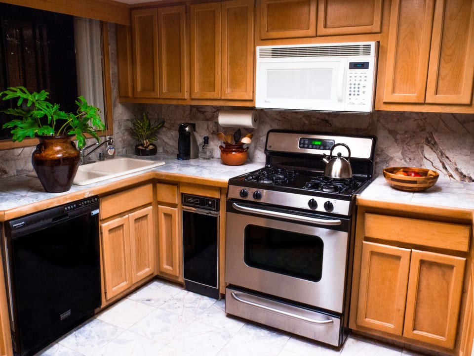Modern updated kitchen includes a dishwasher and all cooking utensils fathomable