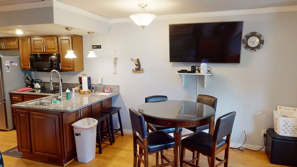 Large dining room table with excellent view of 55" TV.