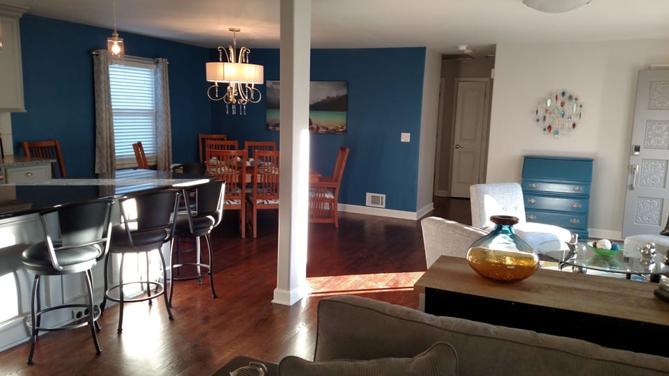 View of open living area of kitchen island and dining area.
