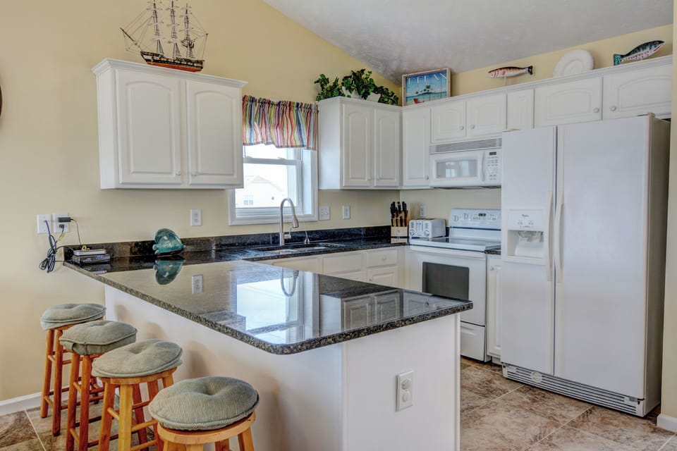 Granite countertops and a breakfast bar area, with a fully equipped kitchen