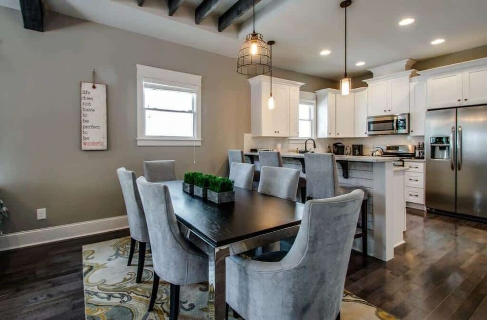 A spacious dining table serves as the centerpiece of this inviting gathering space.