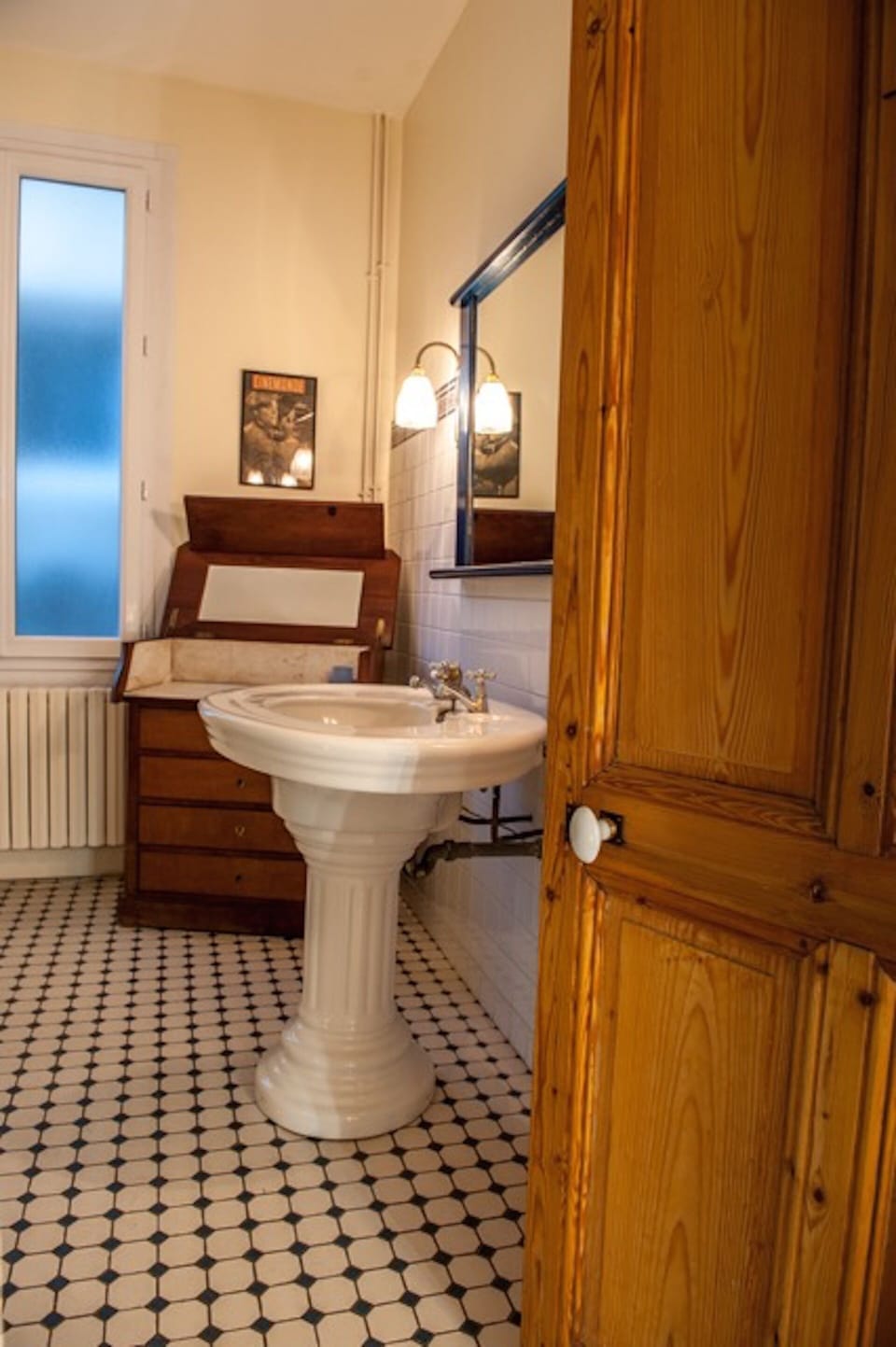 Second floor bathroom with antique bureau and original 1913 sink.