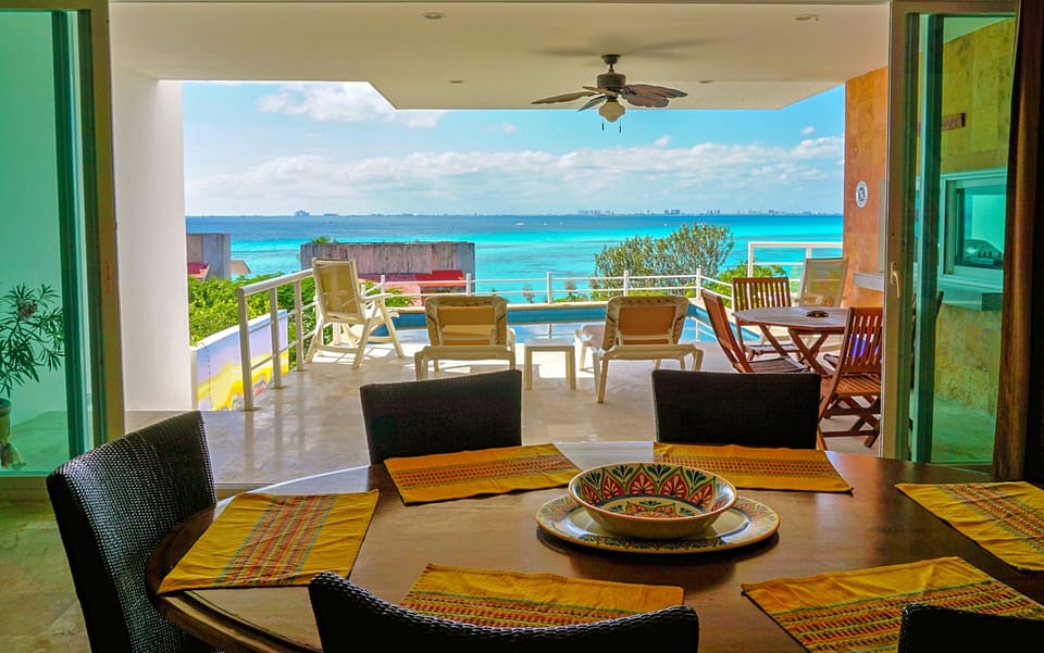 The dining area, complete with sliding glass doors that open fully to the patio