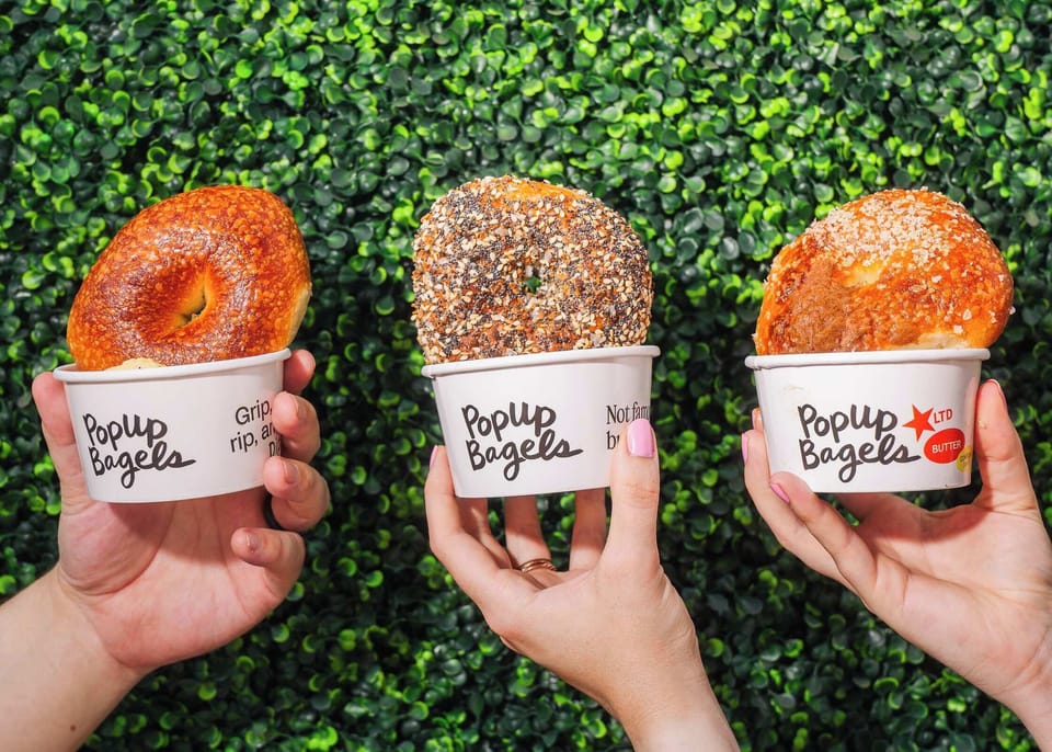Grab breakfast at Popup Bagels, the viral bagel shop known for serving warm, freshly baked bagels by the dozen with rich schmears made for sharing. A fun morning stop just minutes from home.
