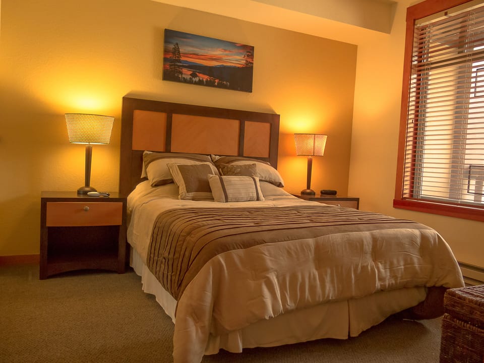 Guest bedroom with queen and beautiful artwork throughout.