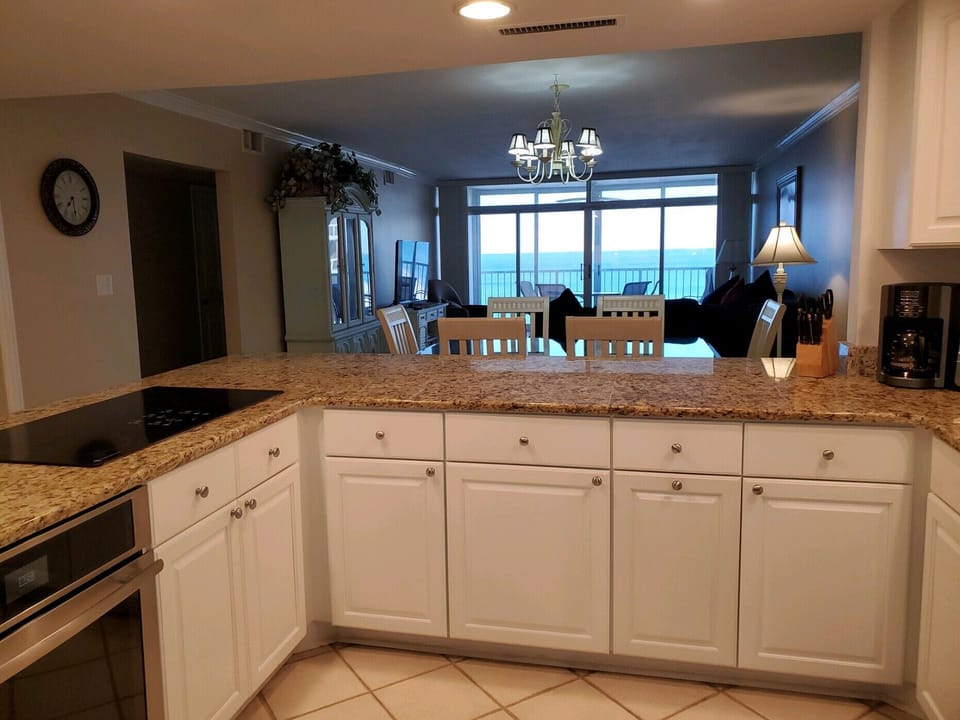 View of Ocean from Kitchen and Living Area. Built in Oven with Glass Cooktop