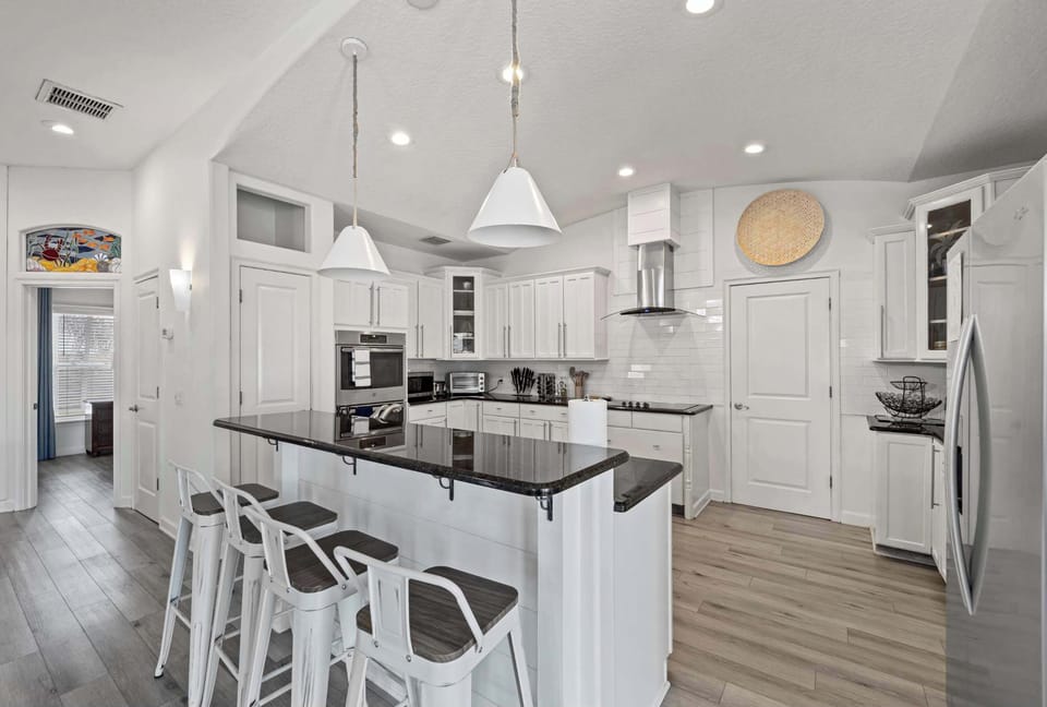 Views of open kitchen w counter top bar seating