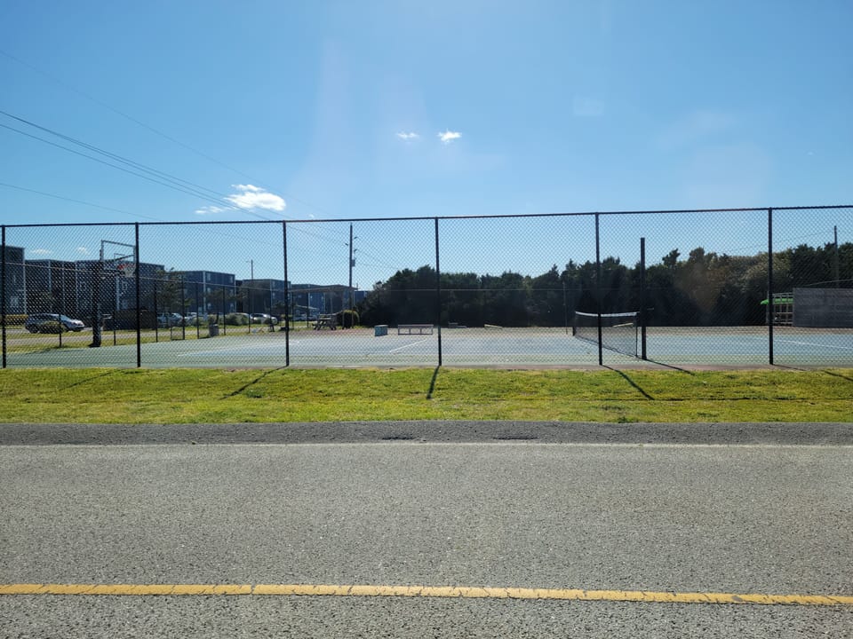 Tennis court, basketball court, corn hole board across street. Bring own ball