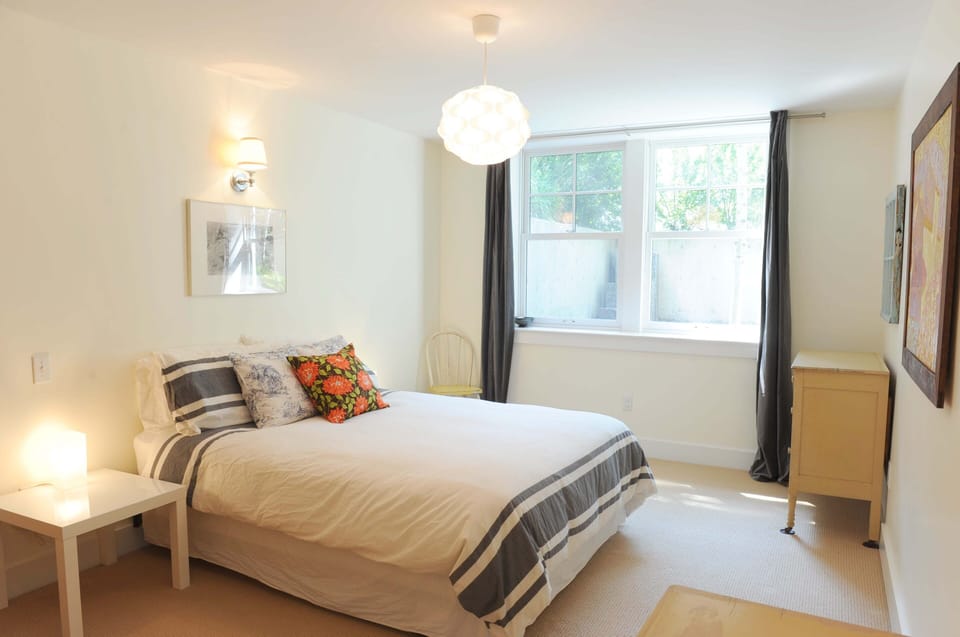 The bedroom has a queen bed with a down duvet and en suite bathroom.