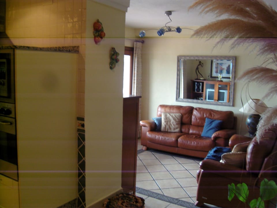 View from kitchen into family /dining room.Cafe doors lead out to terrace pool.