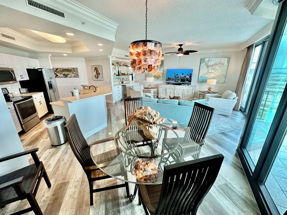 Formal dining comfortably accommodates 6 guests; open floor plan all with views