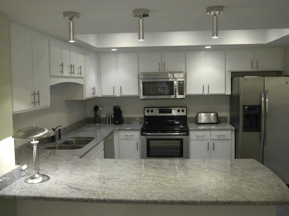 Fully stocked kitchen has new cabinets, stainless steel appliances, granite.