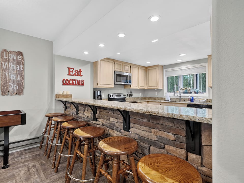 Gather around this rustic stone-front bar, pull up a seat, and whip up your favorite cocktails in a fully equipped kitchen that makes entertaining effortless and fun.