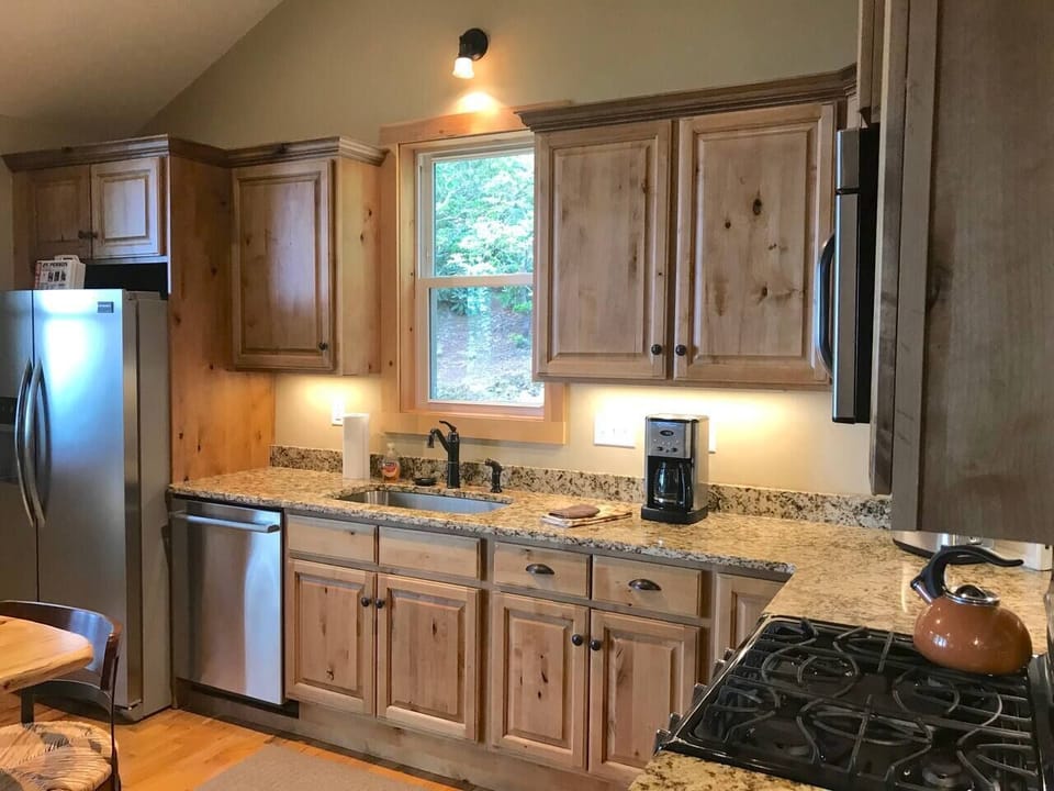 Knotty alder cabinets and stainless steel appliances and gas range