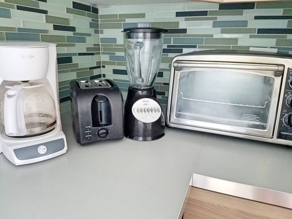 Kitchen has Blender, Toaster, Coffee maker, toaster oven, waffle maker.