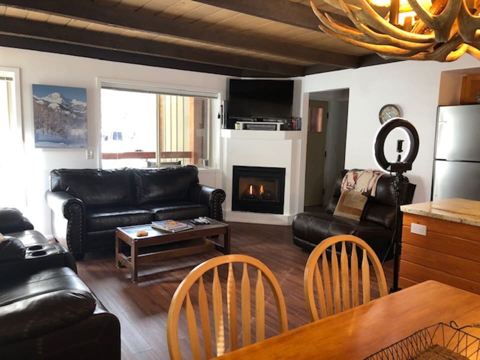 View of living room from dining area.  You can see the front door in the pic.