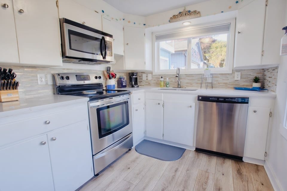 Kitchen has all the dishes to cook and serve with.