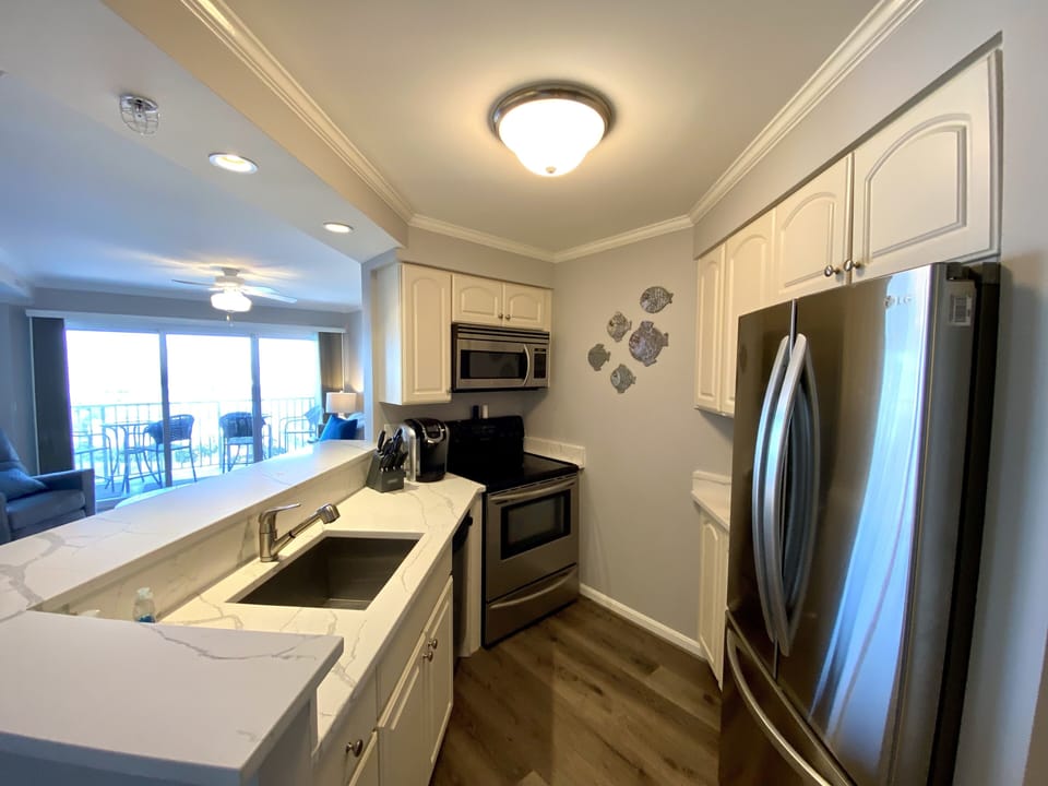 Kitchen with side by side Refrigerator Lower Freezer with Ice Maker