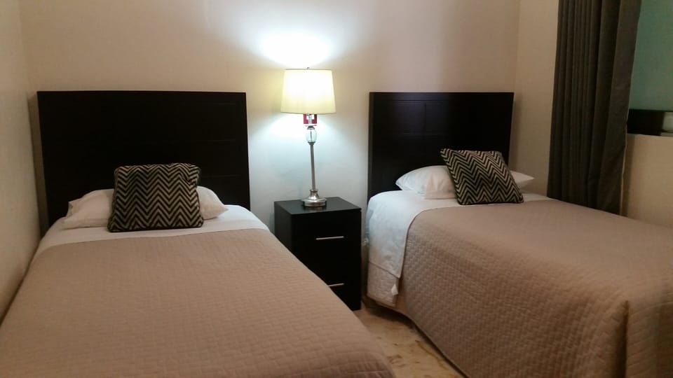 Third bedroom wit 2 single beds, AC and drawers. 