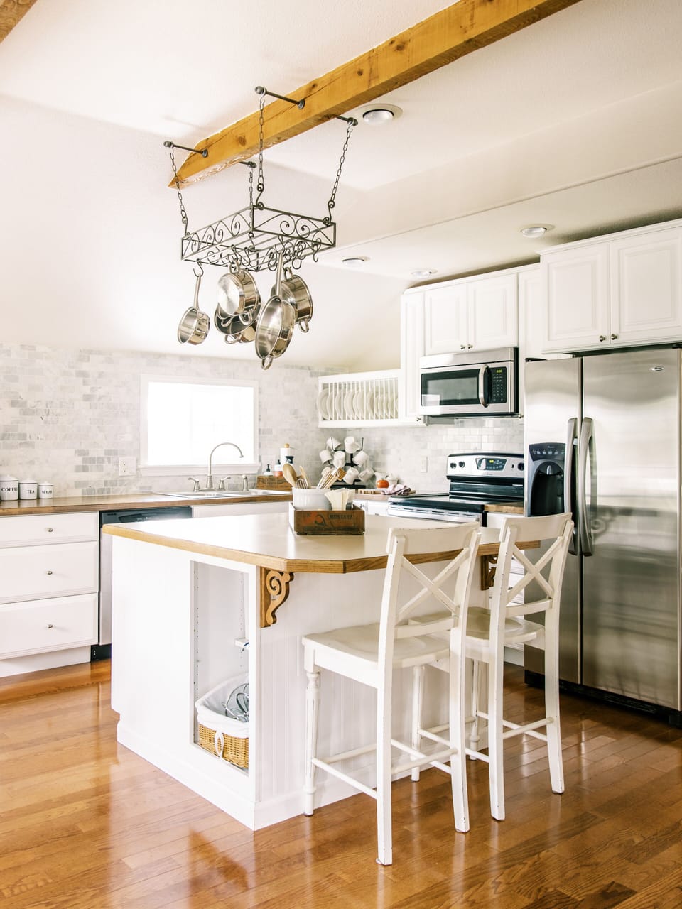 Kitchen includes stainless steel appliances. 