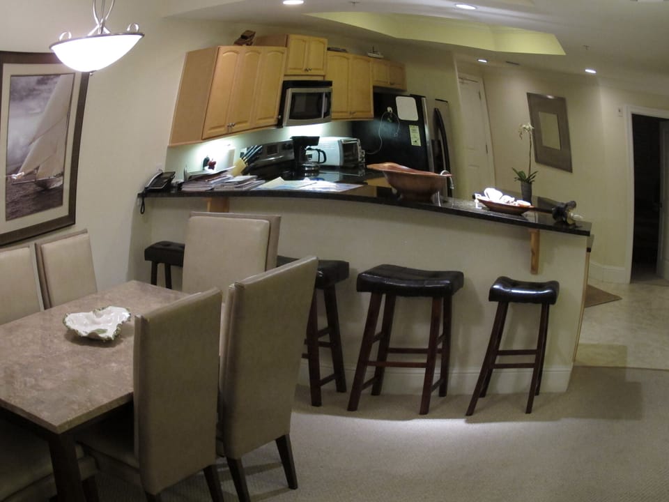 Wide angle view of kitchen & dining area.