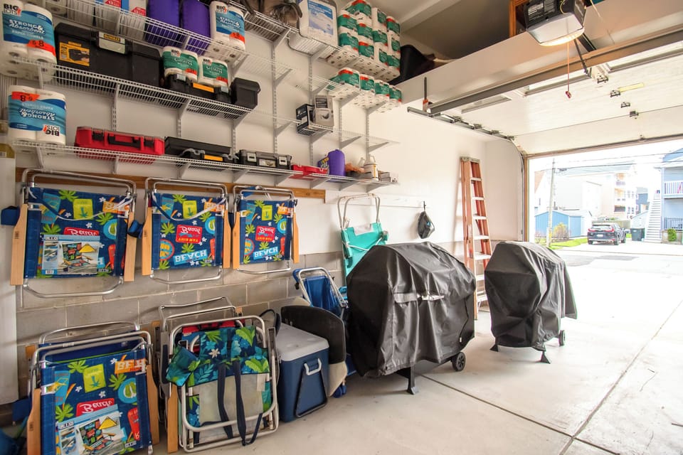 Garage equipped with beach chairs, grill, cooler and wagon